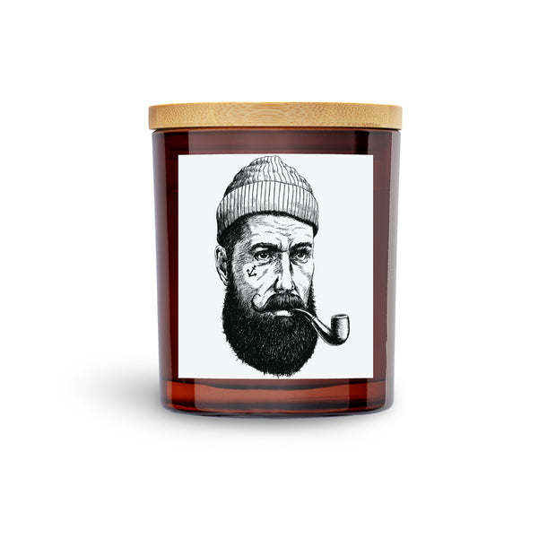 nautical salty sailor pirate scented soy candle.  Cool pirate with tatoo on side of his face.  Amber vessel
